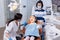 Kid keeping mouth open sitting on dental chair