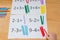 Kid learning simple subtraction and addition by counting sticks