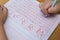 Kid learns to write Arabic numerals by following guide