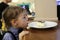 Kid licking plate with cake