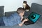 Kid lies on the couch in front of an open laptop, lock symbol appears on the screen, cat is sitting nearby and watching, concept