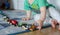 Kid lining up toys on the floor