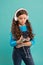Kid listen music in headphones. small child make play list on smartphone. small girl hold mp3 player. choosing favorite