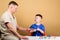 Kid little doctor sit table medical tools. Health care. Medical examination. Boy cute child and his father doctor