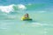 Kid little surfer learn to ride on surfboard on sea waves. Child summer vacation at sat. Summer vacation with child