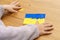 The kid makes Ukraine flag out of plasticine. The concept of patriotism, respect, support, help and solidarity with the