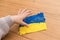 The kid makes Ukraine flag out of plasticine. The concept of patriotism, respect, support, help and solidarity with the