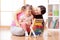 Kid and mother playing with abacus at home interior