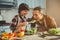 Kid nourishing father with delicious salad