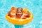 Kid with orange in the pool. Summer fruits. Cute little boy relaxing with toy ring floating in a swimming pool having