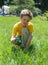 Kid in the park looking the grass with a magnifying glass. Cute boy doing experiments outdoors.