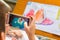 Kid playing Augmented Reality popup paintings of a filled penguin via mobile