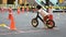 Kid playing balance bike in racetrack, speed motion