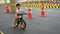 Kid playing balance bike in racetrack, speed motion