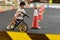 Kid playing balance bike in racetrack, speed motion blur