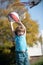 Kid playing basketball with basket ball. Active kids lifestyle.