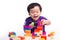 kid playing with block toys, asian small boy playing indoor games, colorful plastic block toys, making toy house, over white