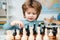 Kid Playing Chess. Kids educational games, child early development. Clever concentrated and thinking child while playing