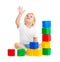 Kid playing with colorful building blocks and looking up