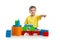 Kid playing with colorful building blocks and pointing direction