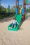 Kid playing in green slide