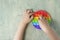 Kid playing with pop it sensory toy. boy pressing on colorful rainbow squishy soft silicone bubbles. Stress and anxiety