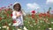Kid Playing in Poppy Flowers, Child in Agriculture Field, Farmer Baby Girl Plays Outdoor in Nature, Happy Children at Countryside