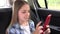 Kid Playing Smartphone in Car, Girl Searching Online, Teenager Child Browsing Internet on Tablet in Traffic, Auto Driving