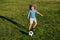 Kid playing soccer, happy child enjoying sports football game, kids activities, little soccer player. Active sporty kid