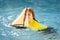Kid playing with toy sailing boat, toy ship. Travel and adventure concept. Child feeling adventurous while cruising. Kid