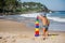 Kid plays with toys at the seashore in summertime