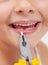 Kid with pliers holding a lost tooth - closeup