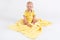 Kid on the plush yellow blanket on the white background