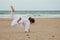 Kid practicing Aikido on the beach