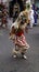 Kid with a prehispanic costume dancing