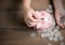 Kid put coin to piggy bank on the vintage wood background