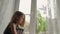 Kid putting on window of doves symbolizing peace