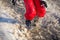 Kid in rainboots jumping in the ice puddle