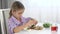 Kid Reading Book in Kitchen, Child Face Drinking Tea, Girl Eating Eggs and Fresh Salad at Breakfast, Children Education