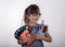 Kid ready for school. Cute clever child in eyeglasses holding school supplies: pens, notebooks, scissors and apple.