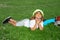Kid relaxing on green meadow. Child relax at the summer park. Kid boy lying on green grass outdoor.