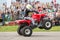 Kid rides on the rear wheels on a quad bike