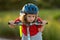 Kid riding bike in a helmet. Child riding bike in protective helmet. Safety kids sports and activity. Happy kid boy