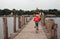 Kid riding bike on U-Bein bridge in Mandalay