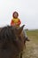 kid riding on horse alone