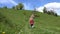 Kid Running Down the Hill in Mountains, Child Playing Outdoor in Camping, Rural, Rustic Girl Jumping on Meadow in Alpine Trip