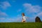 Kid running on grass field. Cute boy run in summer park. Child running on meadow.