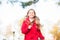 Kid in running motion outdoor. Child blonde long hair run warm jacket outdoor. Girl happy in red coat enjoy fall nature