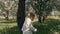 Kid runs on green grass. Little boy takes first step on fresh grass in city park