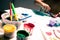 kid\\\'s drawing, painting with a brush and hands with color temperas on paper